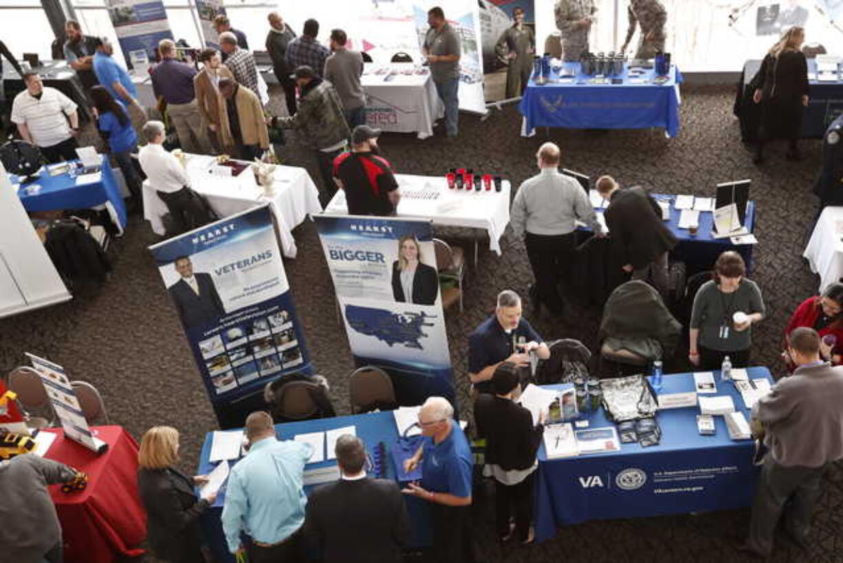 In this March 7, 2019, photo visitors to the Pittsburgh veterans job fair meet with recruiters at Heinz Field in Pittsburgh. On Friday, May 3, the U.S. government issues the April jobs report.