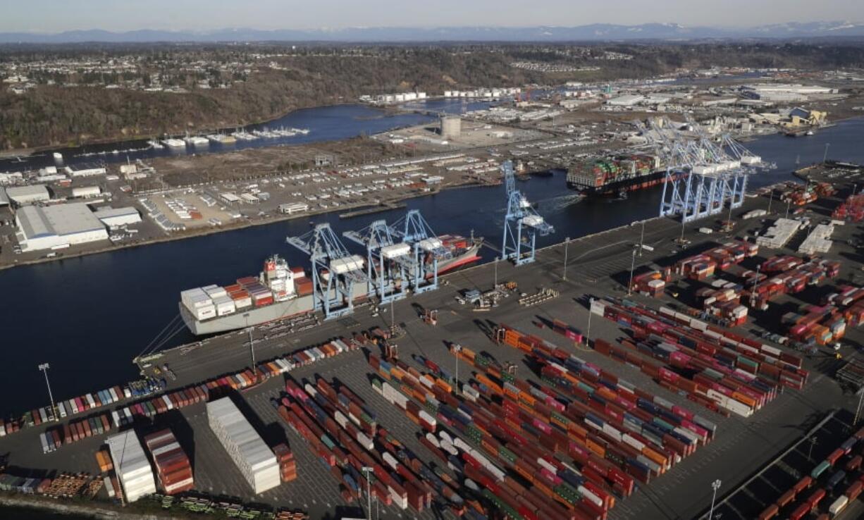 Cargo containers are staged near cranes March 5 at the Port of Tacoma, in Tacoma. Farmers are expressing renewed fear and frustration with the U.S.-China trade war, as China is a major market for American farmers.