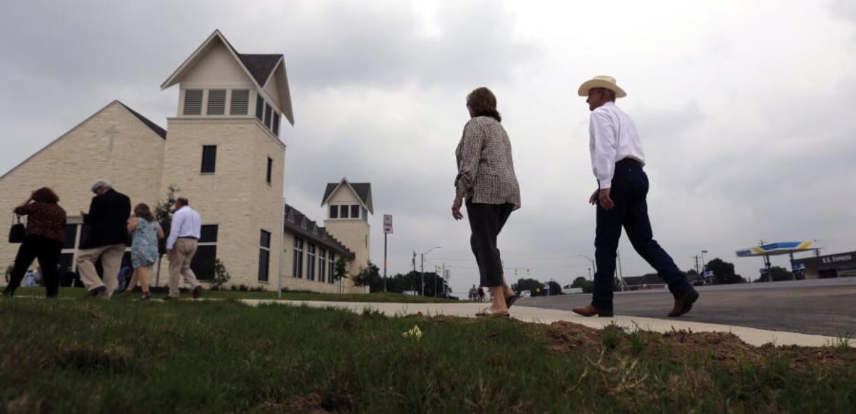 Churchgoers arrive for a dedication ceremony for a new sanctuary and memorial room at the First Baptist Church in Sutherland Springs, Texas, Sunday, May 19, 2019. In 2017 a gunman opened fire at the church and killed more than two dozen congregants.