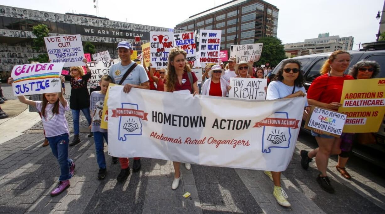 In this May 19, 2019, photo, protesters for women’s rights march to the Alabama Capitol to protest a law passed last week making abortion a felony in nearly all cases with no exceptions for cases of rape or incest in Montgomery, Ala. Members of both parties say a flood of laws banning abortions in Republican-run states has handed Democrats a daunting weapon for next year’s elections. They say the restrictions will help Democrats paint the GOP as extreme and woo centrist voters who could decide tight House and Senate races.