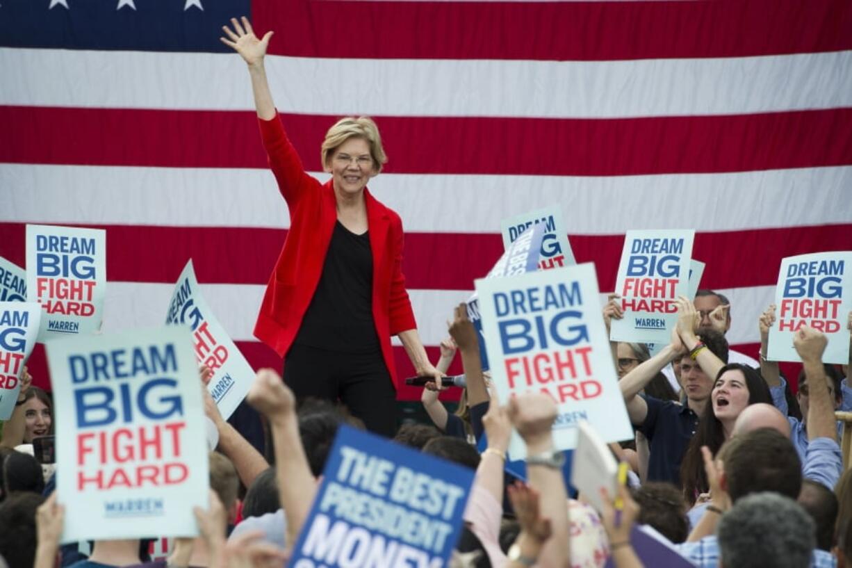 In this May 16, 2019, photo, Democratic presidential candidate Sen. Elizabeth Warren, D-Mass., addresses a campaign rally at George Mason University in Fairfax, Va. Warren is gaining traction with black women debating which Democratic presidential candidate to back in a historically diverse primary.