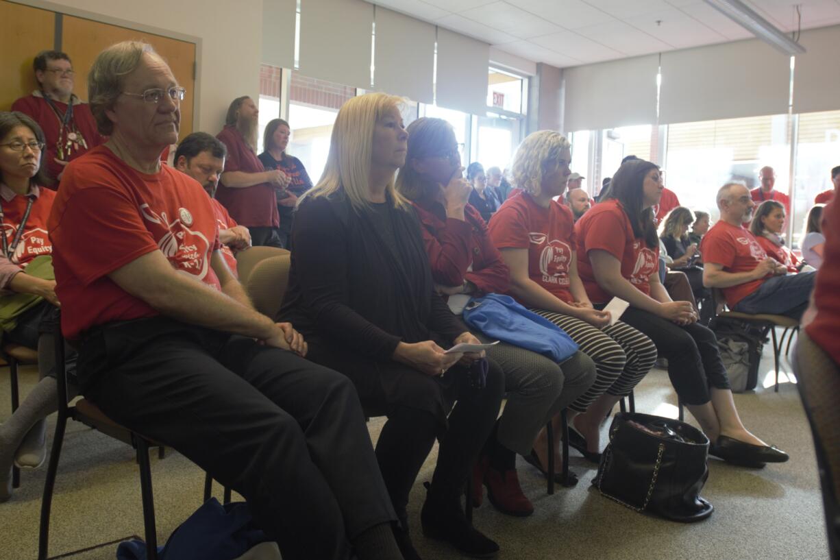 Clark College faculty listen at a board of trustees meeting Wednesday. The faculty union, the Association for Higher Education, is in the midst of bargaining with Clark College administration, advocating for higher wages.