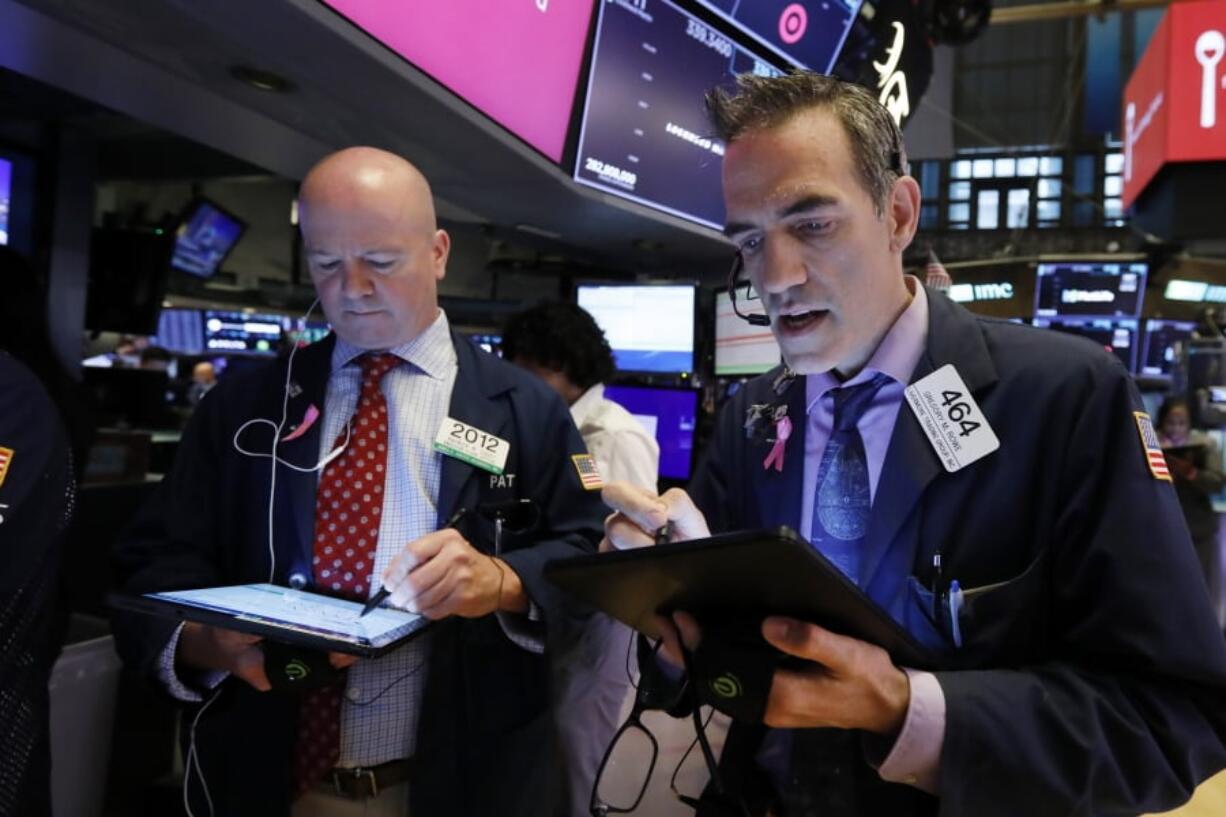 Traders Patrick Casey, left, and Gregory Rowe work on the floor of the New York Stock Exchange, Thursday, May 30, 2019. Stocks are edging higher in early trading on Wall Street following two days of losses.