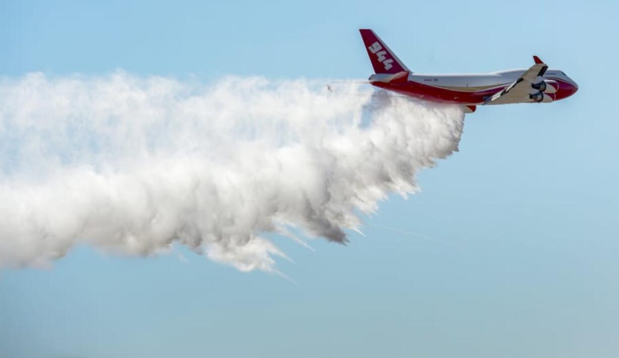 FILE - In this May 5, 2016, file photo, the Boeing 747-400 Global SuperTanker drops half a load of its 19,400-gallon capacity during a ceremony at Colorado Springs, Colo. The Global SuperTanker, the world’s largest firefighting aircraft, has been readied for the 2019 wildfire season. The Boeing 747-400 series passenger jet converted for firefighting underwent maintenance recently at Pinal Airpark outside Tucson, Ariz.