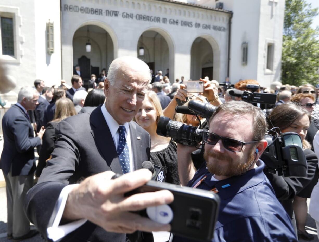 Former Vice President Joe Biden takes a selfie following the funeral for former U.S. Sen. Ernest “Fritz” Hollings at the Summerall Chapel on The Citadel campus Tuesday, April 16, 2019, in Charleston, S.C. Biden delivered one of the eulogies for his former Senate colleague. Hollings died earlier this month at age 97.