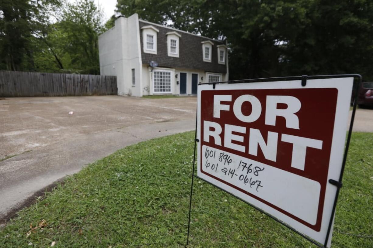 FILE - In this April 23, 2018, file photo a for rent sign denotes the availability of another existing home in Jackson, Miss. Buying a home is often seen as a no-brainer if you have the means. But continuing to rent can give you more flexibility, amenities and time. It can also give you a sense of financial security, since there’s no down payment, repairs or closing costs to eat through your nest egg. (AP Photo/Rogelio V.