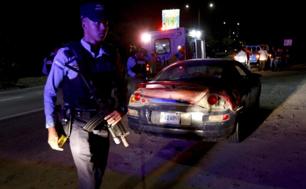 Police and paramedics gather around a vehicle where the body of an unidentified man lies inside, after he died on his way to the hospital after suffering stab wounds in San Pedro Sula, Honduras, Wednesday, May 1, 2019. San Pedro Sula was the world’s most murderous city four years straight from 2011 to 2014, and the country’s nation-wide murder rate in 2018 was 41 per 100,000, one of the highest on the planet.