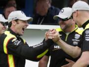 Simon Pagenaud, of France, celebrates with his crew after winning the pole during qualifications for the Indianapolis 500 IndyCar auto race at Indianapolis Motor Speedway, Sunday, May 19, 2019 in Indianapolis.