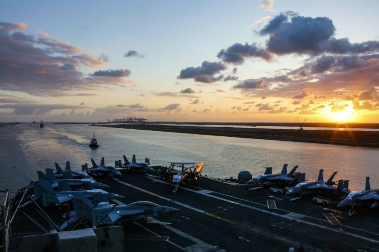 In this Thursday, May 9, 2019 photo released by the U.S. Navy, the Nimitz-class aircraft carrier USS Abraham Lincoln transits the Suez Canal in Egypt. The aircraft carrier and its strike group are deploying to the Persian Gulf on orders from the White House to respond to an unspecified threat from Iran. (Mass Communication Specialist Seaman Dan Snow, U.S.