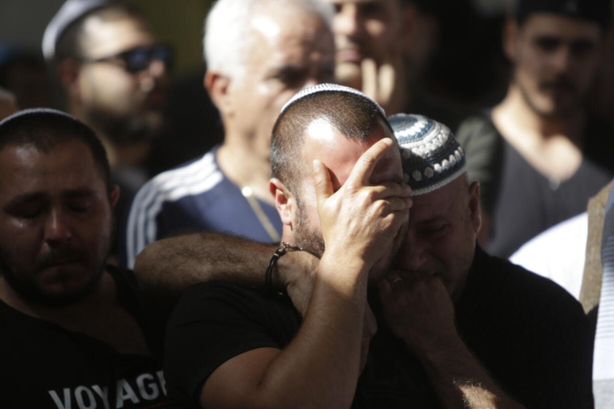 People cry during the funeral of Moshe Agadi in the city of Ashkelon, Israel, Sunday.May 5, 2019. Agadi was killed outside his home in Ashkelon by a rocket fired from Gaza Strip.