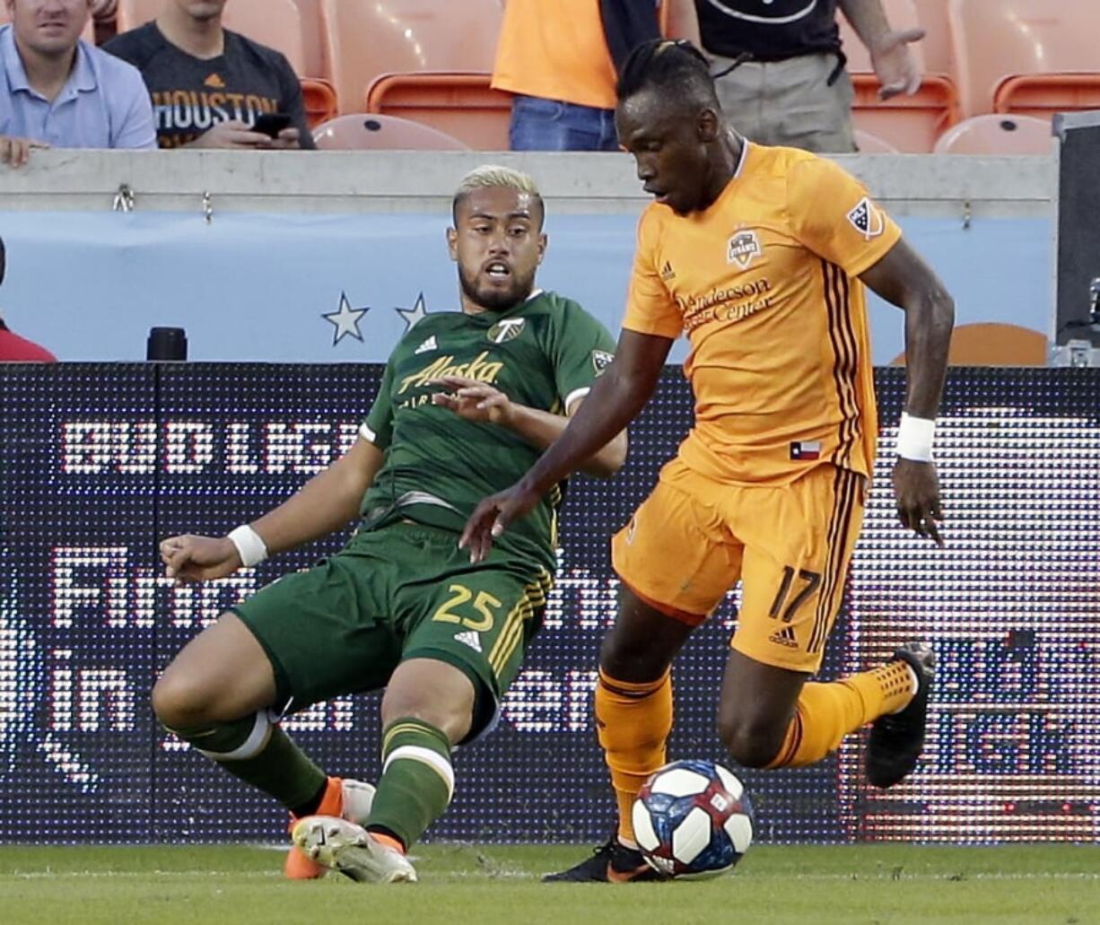 Portland Timbers defender Bill Tuiloma (25) tries to take the ball from Houston Dynamo forward Alberth Elis (17) during the first half of an MLS soccer match Wednesday, May 15, 2019, in Houston.