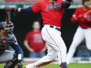 Cleveland Indians’ Carlos Santana hits a two-run home run off Seattle Mariners relief pitcher Connor Sadzeck during the eighth inning of a baseball game, Saturday, May 4, 2019, in Cleveland. The Indians defeated the Mariners 5-4.