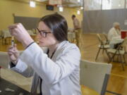 University of Pittsburgh pharmacy student Alexandria Taylor prepares syringes during a free measles vaccination clinic by the Allegheny County Health Department at the Homewood-Brushton YMCA in Pittsburgh.