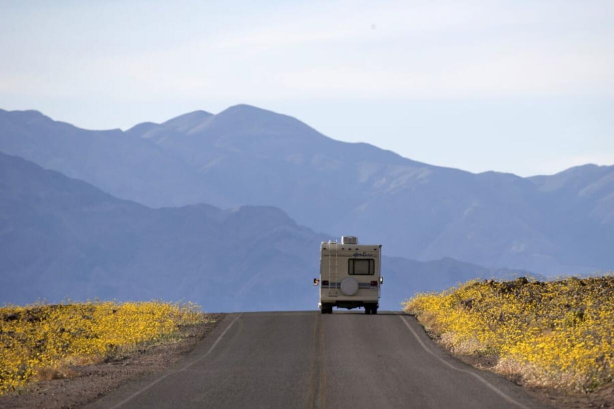 Wildflowers bloom as an RV travels along the road near Badwater Basin in Death Valley, Calif., on Feb. 24, 2016. Heading out on a road trip in a recreational vehicle allows travelers a unique opportunity to explore the nation while enjoying some comforts, too.