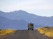 Wildflowers bloom as an RV travels along the road near Badwater Basin in Death Valley, Calif., on Feb. 24, 2016. Heading out on a road trip in a recreational vehicle allows travelers a unique opportunity to explore the nation while enjoying some comforts, too.