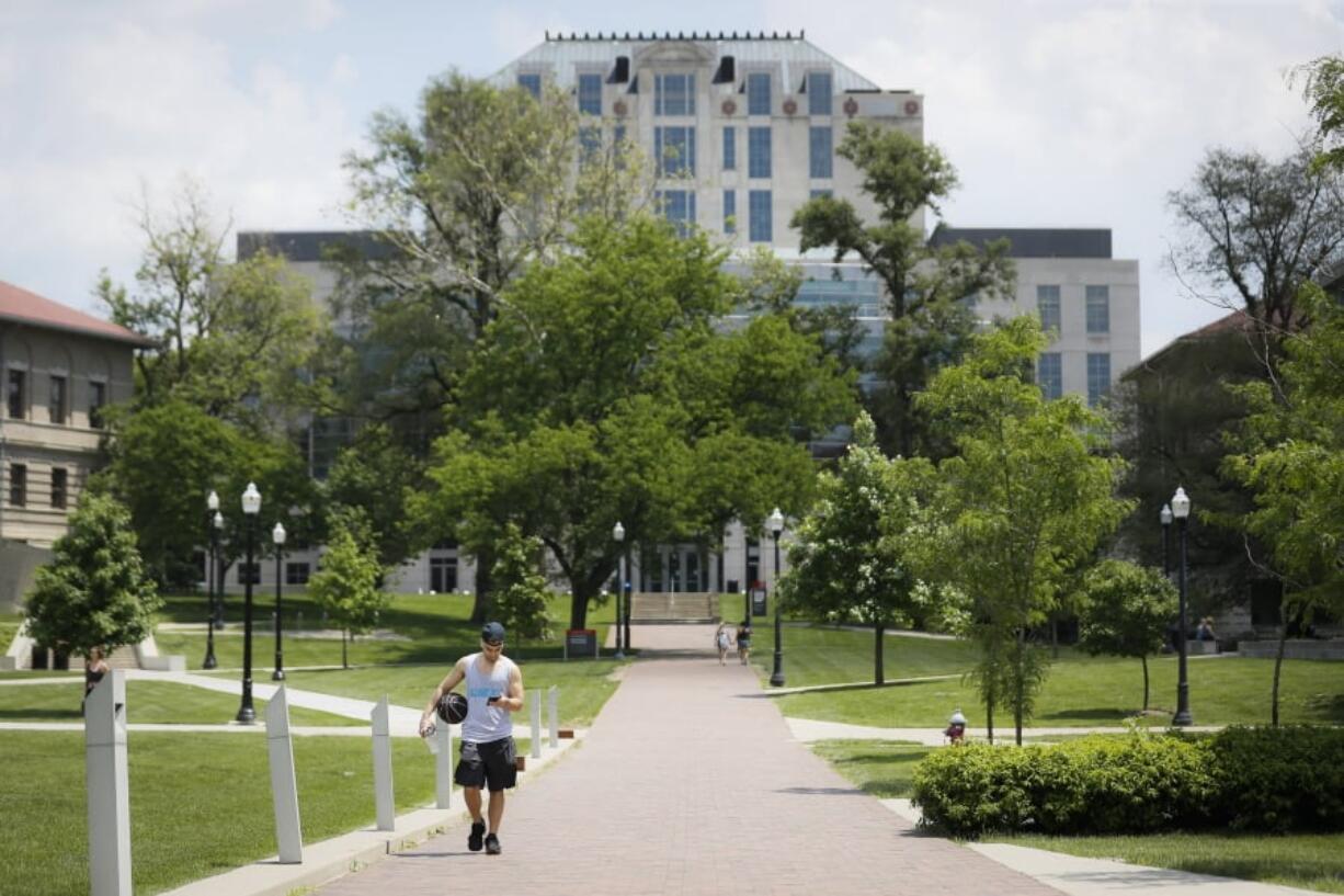 Pedestrians walk towards The Ohio State University’s athletics facilities, Saturday, May 18, 2019, in Columbus, Ohio. Dr. Richard Strauss, a now-dead Ohio State team doctor sexually abused at least 177 male students from the 1970s through the 1990s, and numerous university officials got wind of what was going on over the years but did little or nothing to stop him, according to a report released by the school Friday.