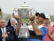 Brooks Keopka holds up the Wanamaker Trophy after winning the PGA Championship golf tournament, Sunday, May 19, 2019, at Bethpage Black in Farmingdale, N.Y.