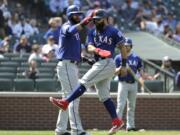 Texas Rangers’ Nomar Mazara, left, and Rougned Odor, right, react after they both scored on a two-run single hit by Shin-Soo Choo during the eighth inning of a baseball game against the Seattle Mariners, Wednesday, May 29, 2019, in Seattle. The Rangers won 8-7. (AP Photo/Ted S.