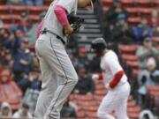 Seattle Mariners’ Marco Gonzales, left, steps on the mound as Boston Red Sox’s J.D. Martinez, right, runs the bases toward home after hitting a home run off a pitch from him in the first inning of a baseball game at Fenway Park, Sunday, May 12, 2019, in Boston.