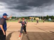 Kaia Oliver is congratulated after a strikeout to end the sixth inning in the 2A state quarterfinals against Ephrata on Friday in Selah. Oliver struck out 20 batters in the 6-0 Ridgefield victory.