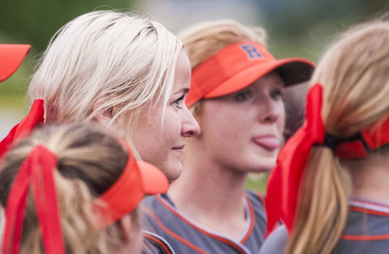 Ridgefield's Emma Jenkins listen to her coaches as tears well in her eyes following a 6-5 win over W.F. West in 2A district tournament play Friday at Longview's Seventh Avenue Park.