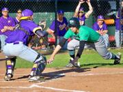 Columbia River catcher Xavier Ulrich receivers the throw from left fielder Cole Delich to tag out Tumwater's Damon Gaither in a 2A district semifinal baseball game Wednesday at Ed Wheeler Field in Centralia. Columbia River won 10-4.