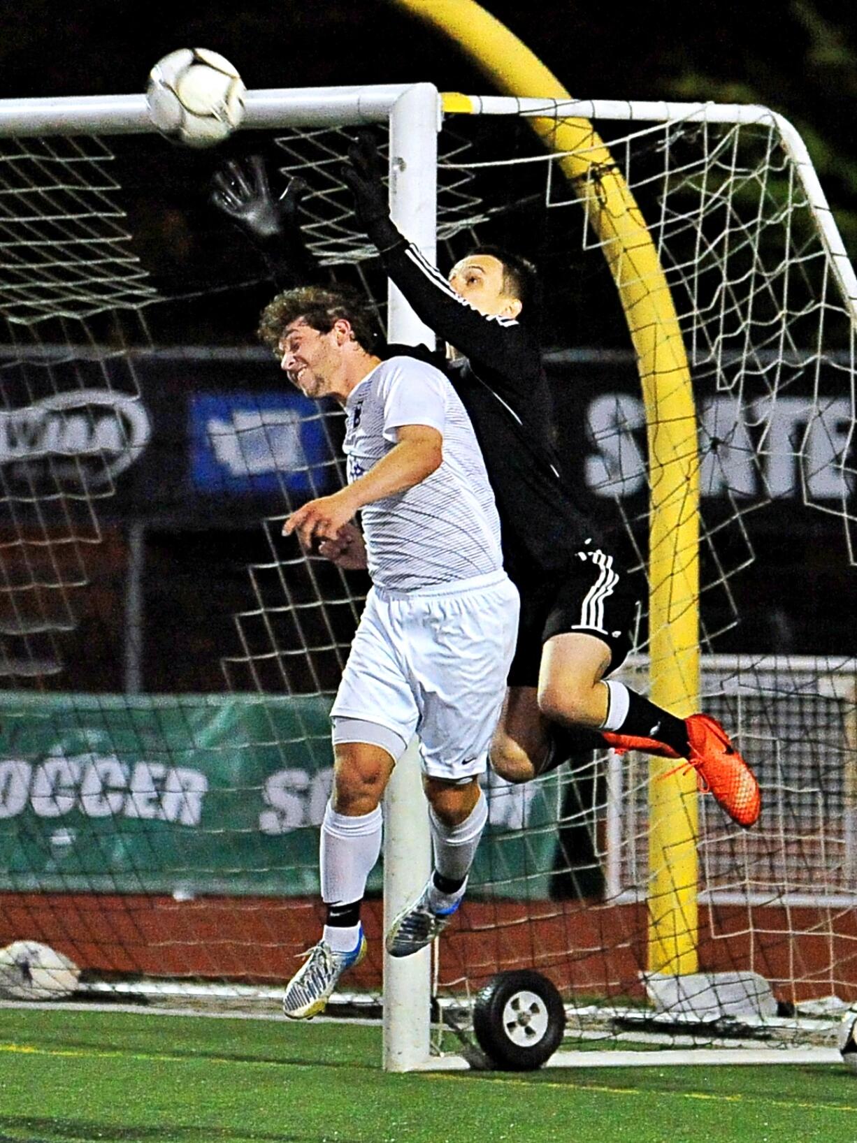 Columbia River's Jake Connop and Fife's Tanner Guisch fight for a ball in a 2A State semifinal game Friday at Sunset Chev Stadium in Sumner. Columbia River won 1-0.