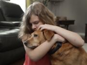 Sobie Cummings, 11, plays with her dog, Dallas, at the family’s home in Waxhaw, N.C., Friday, March 29, 2019. A psychiatrist suggested that a service dog might help to ease Sobie’s crippling anxiety and feelings of isolation. But when they brought home a $14,500 Briard from Mark Mathis’ Ry-Con Service Dogs, Okami broke from Glenn Cummings’ grasp and began mauling Dallas.