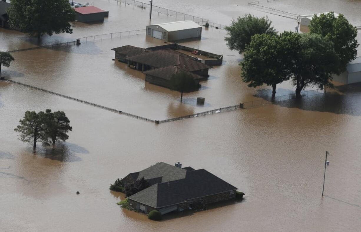 Homes are flooded on the Arkansas River in Tulsa, Okla., on Friday, May 24, 2019. The threat of potentially devastating flooding continued Friday along the Arkansas River from Tulsa into western Arkansas.