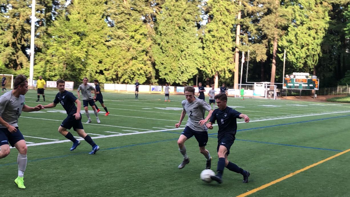 Skyview midfielder Benjamin Picinich, right, dribbles the ball during a 4A bi-district soccer match against Rogers-Puyallup on Thursday at Kiggins Bowl (Micah Rice/The Columbian)