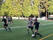 Skyview midfielder Benjamin Picinich, right, dribbles the ball during a 4A bi-district soccer match against Rogers-Puyallup on Thursday at Kiggins Bowl (Micah Rice/The Columbian)