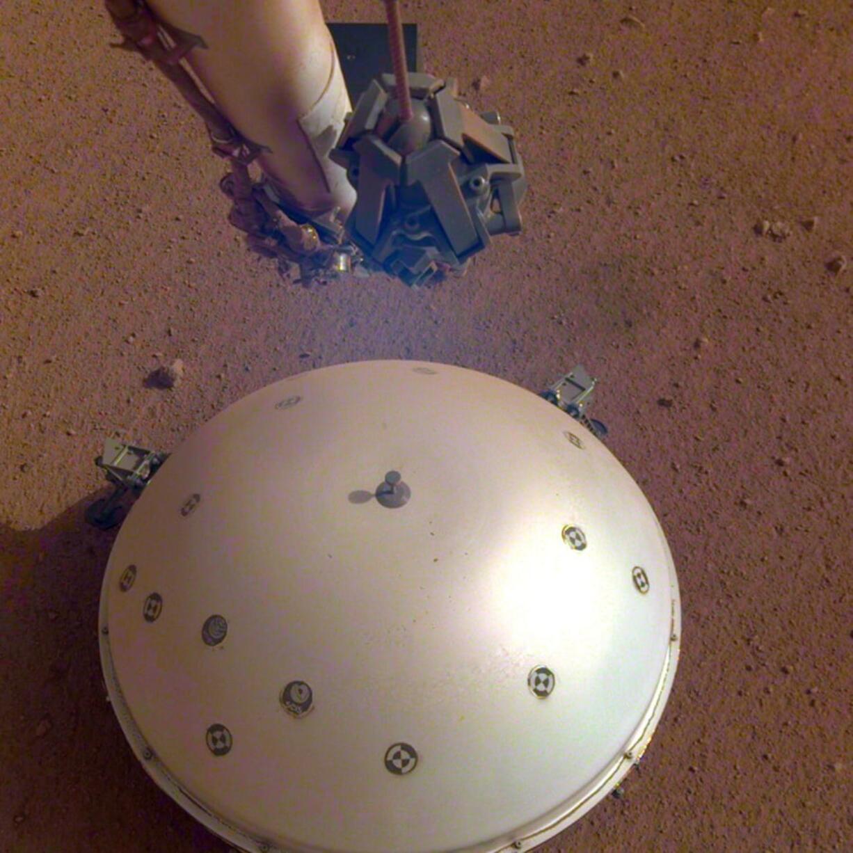 This photo made available by NASA on April 23 shows the InSight lander’s domed wind and thermal shield which covers a seismometer on the 110th Martian day, or sol, of the mission.