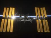 This March 25, 2009 photo provided by NASA shows the International Space Station seen from the Space Shuttle Discovery during separation. In the background is Earth’s atmosphere seen as a blue arc. On Tuesday, April 30, 2019, NASA announced that a major power shortage at the station has delayed a SpaceX supply run later in the week.