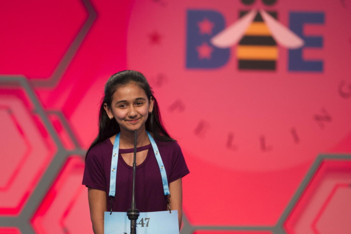 FILE - In this May 31, 2018, file photo, Naysa Modi, 12, from Frisco, Texas, spells her word incorrectly during the evening finals of the Scripps National Spelling Bee in Oxon Hill, Md. Ties are back at the Scripps National Spelling Bee. To the relief of many participants, bee organizers have gotten rid of the written test spellers took just in case a single champion couldn’t be identified during the ESPN-televised finals.