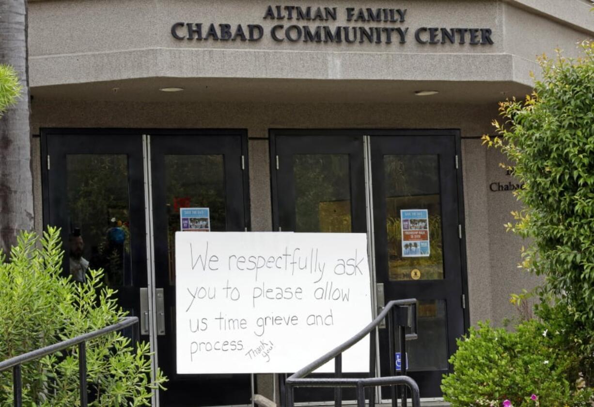 FILE - In this April 29, 2019 file photo, A sign asks for time to grieve at the Chabad of Poway synagogue in Poway, Calif. The gunman who attacked the synagogue last week fired his semi-automatic rifle at Passover worshippers after walking through the front entrance that synagogue leaders identified last year as needing improved security. The synagogue applied for a federal grant to better protect that area. The money, $150,000, was approved in September but only arrived in late March.