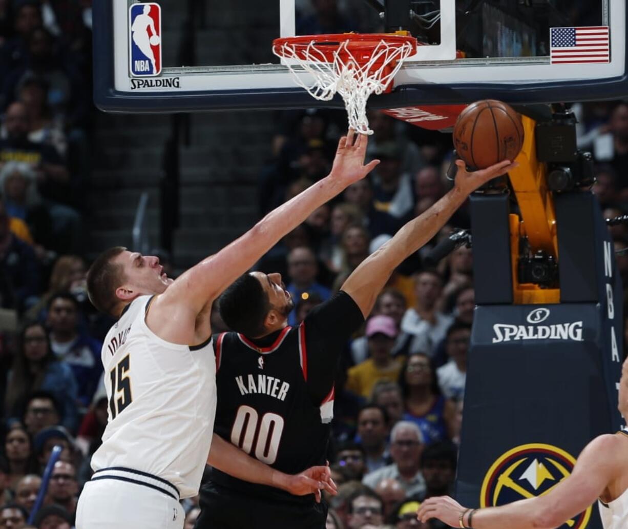 Portland Trail Blazers center Enes Kanter (00) shoots as Denver Nuggets center Nikola Jokic (15) defends in the first half of Game 5 of an NBA basketball second-round playoff series, Tuesday, May 7, 2019, in Denver.