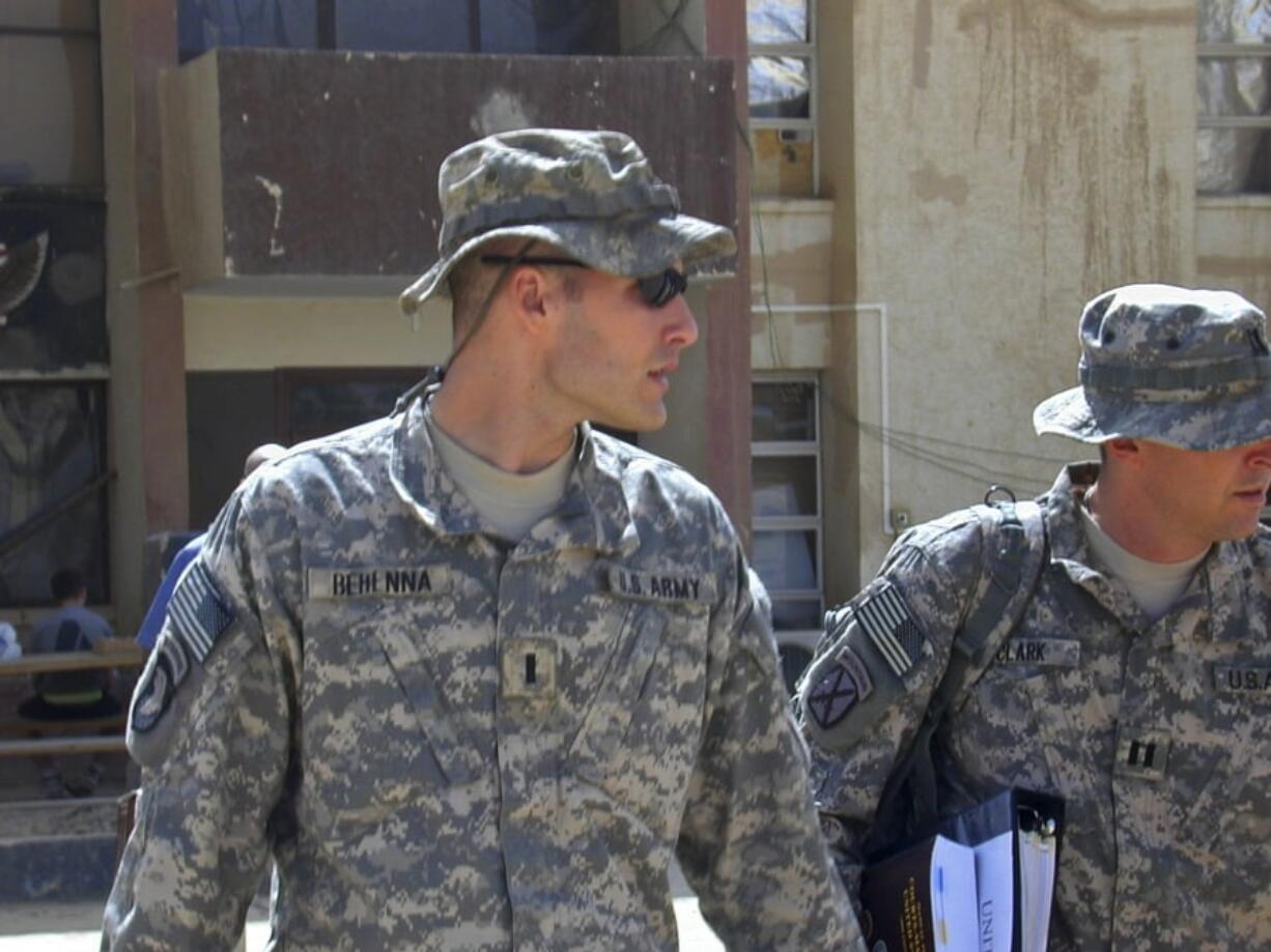 FILE - In this Sunday, Sept. 21, 2008, file photo, 1st Lt. Michael C. Behenna, left, and his defense attorney Capt. Tom Clark, right, walk in Camp Speicher, a large U.S. base near Tikrit, north of Baghdad, Iraq. The White House announced Monday, May 6, 2019, that President Donald Trump pardoned Behenna, a former U.S. soldier convicted in 2009 of killing an Iraqi prisoner.