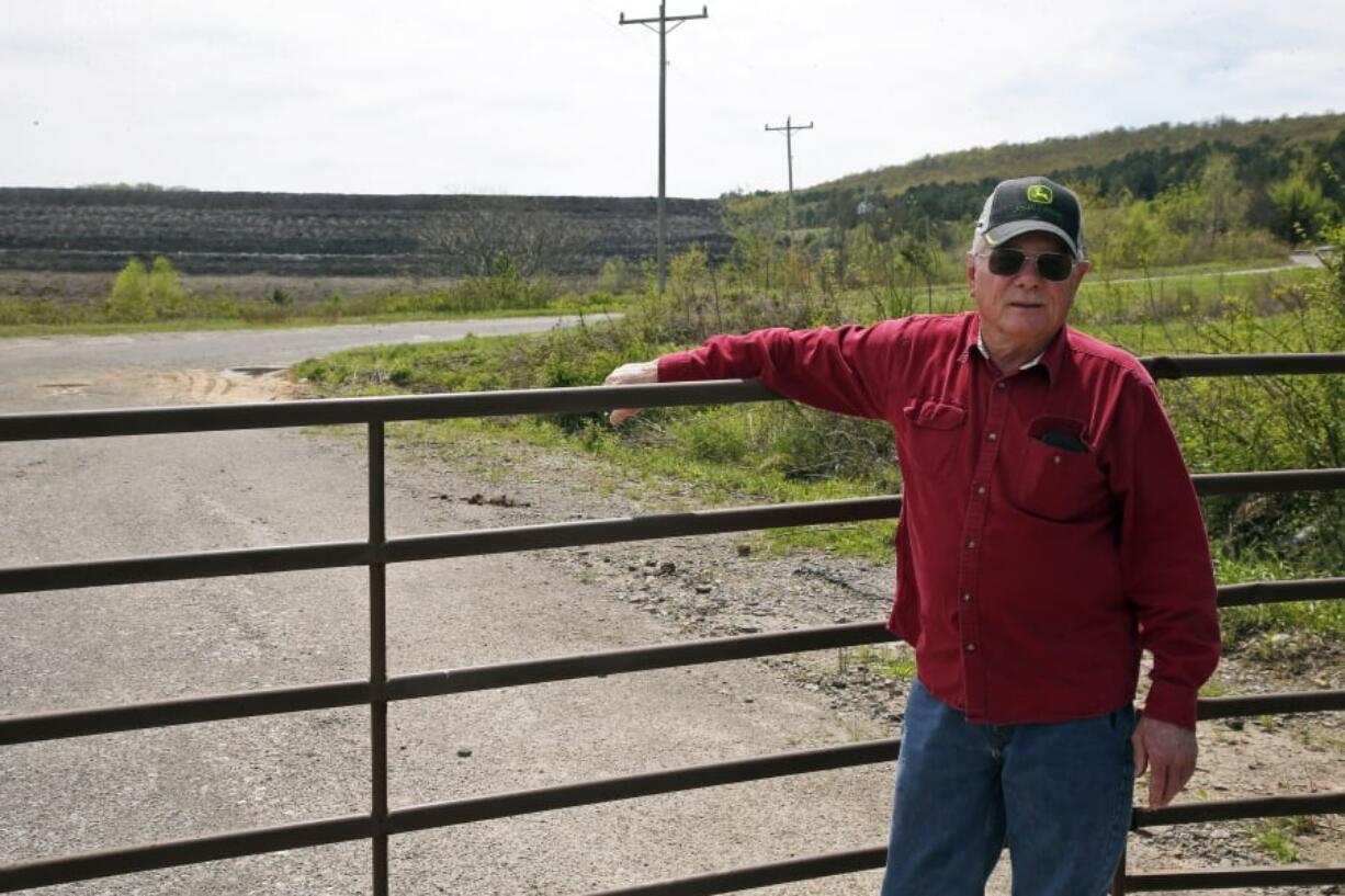 In this April 8, 2019, photo, Tim Tanksley, who has been fighting for years trying to convince Oklahoma lawmakers to crack down on the coal ash dumping, stands outside a dump site in Bokoshe, Okla. President Donald Trump’s EPA has approved Oklahoma to be the first state to take over permitting and enforcement on coal-ash sites. “They’re going to do absolutely nothing,” Tanksley said.