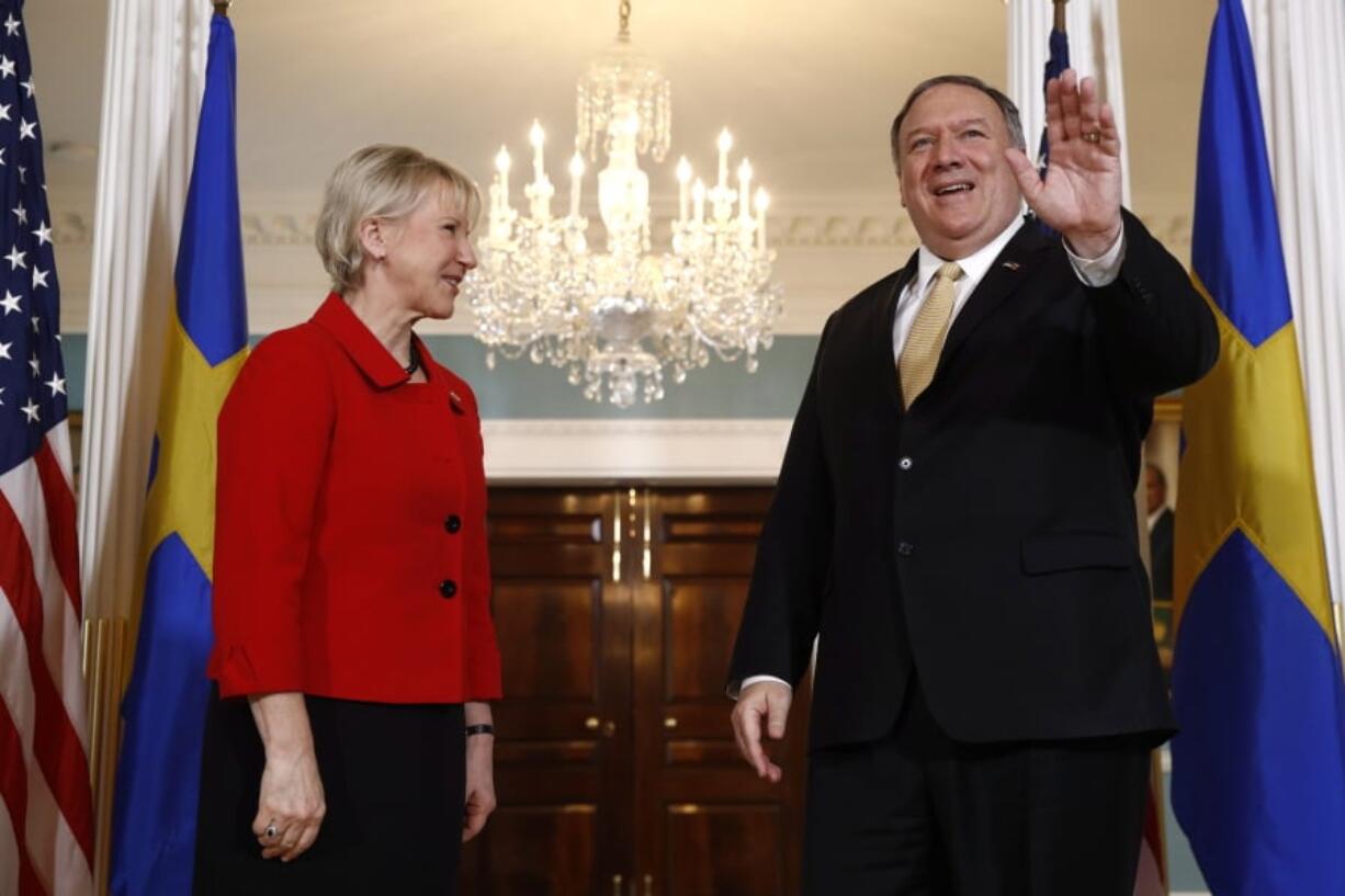 Secretary of State Mike Pompeo, right, waves as he stands alongside Swedish Foreign Minister Margot Wallstrom, Monday, April 29, 2019, at the U.S. State Department in Washington.