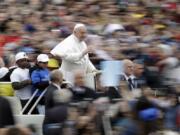 Pope Francis rides with a group of migrant children who recently arrived from Libya, on his popemobile at the start of his weekly general audience in St. Peter’s Square, at the Vatican, Wednesday May 15, 2019.