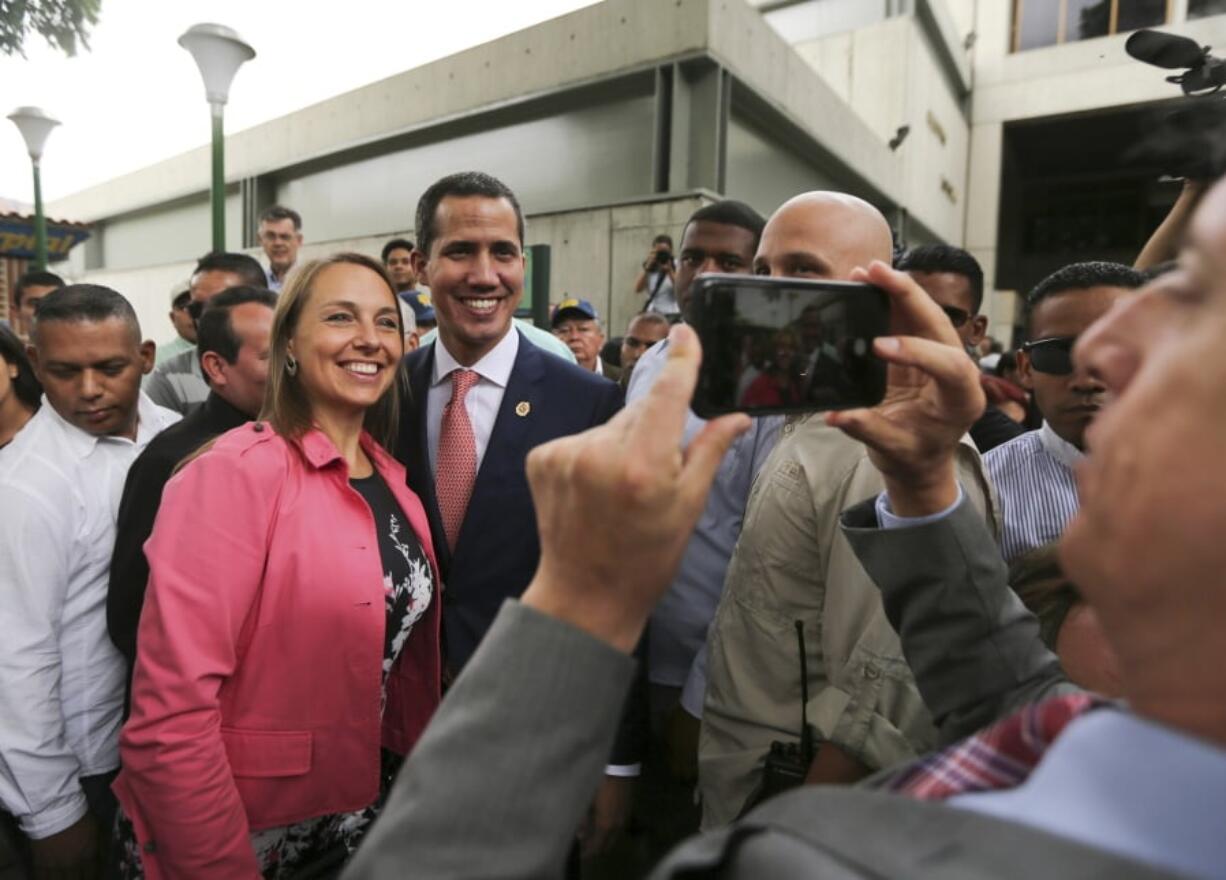 Venezuela’s opposition leader and self-proclaimed interim president Juan Guaido, center, poses for a selfie photo with supporters after a meeting of “Plan Pais” or Country Plan at University Catholic Andres Bello in Caracas, Venezuela, Friday, May 24, 2019.(AP Photo/Fernando Llano)