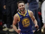 Golden State Warriors guard Stephen Curry reacts at the end of Game 4 of the NBA basketball playoffs Western Conference finals against the Portland Trail Blazers, Monday, May 20, 2019, in Portland, Ore. The Warriors won 119-117 in overtime. (AP Photo/Ted S.