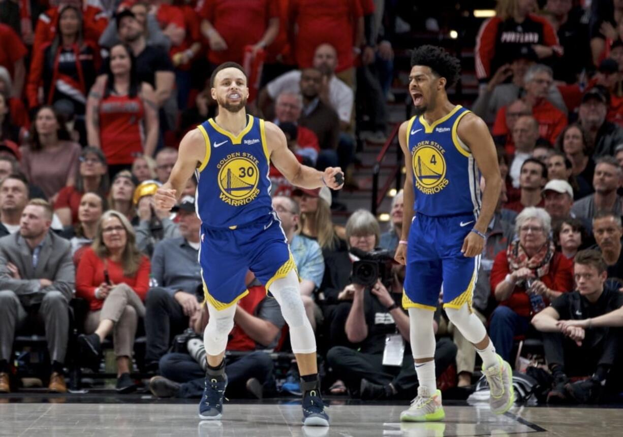 Golden State Warriors guard Stephen Curry, left, and guard Quinn Cook react after Curry made a basket against the Portland Trail Blazers during the second half of Game 4 of the NBA basketball playoffs Western Conference finals Monday, May 20, 2019, in Portland, Ore. The Warriors won 119-117 in overtime.