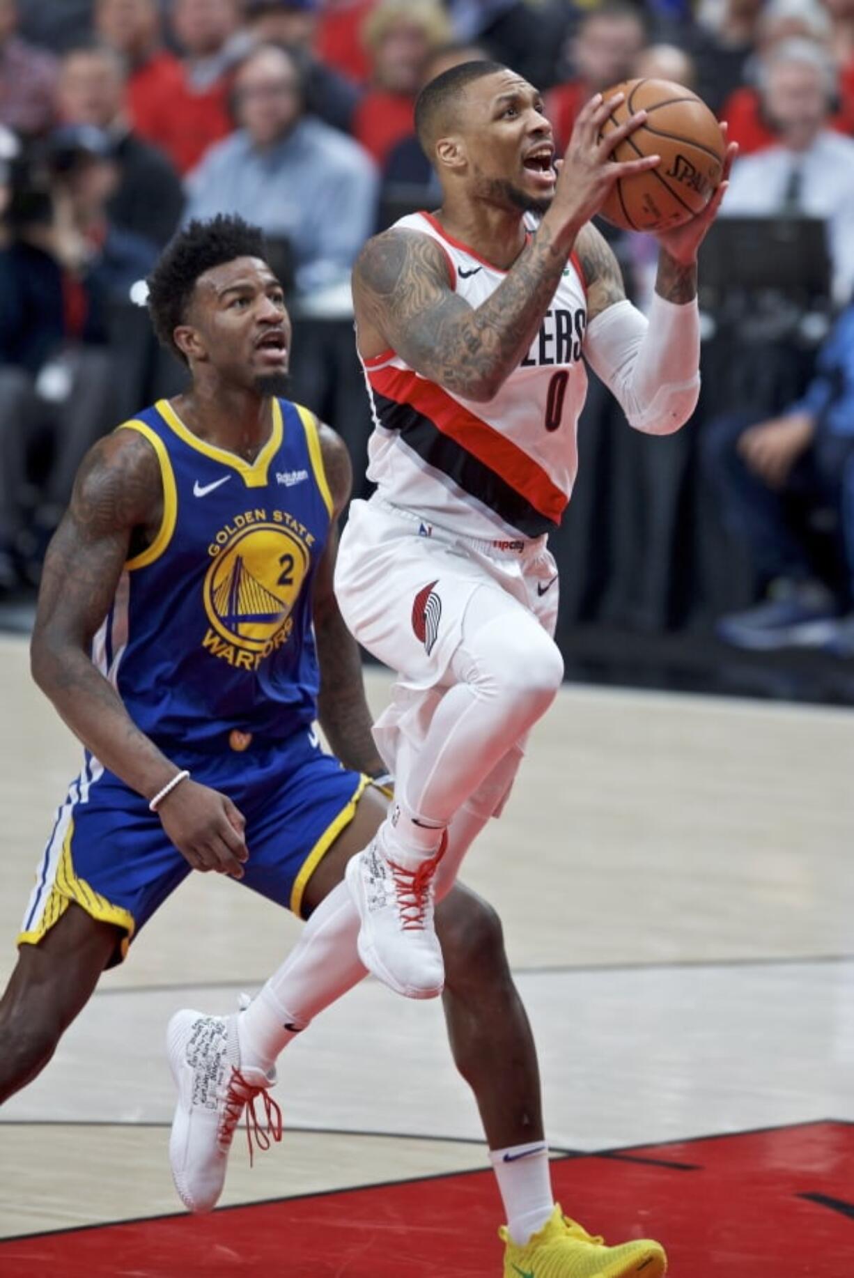 Portland Trail Blazers guard Damian Lillard, right, shoots past Golden State Warriors forward Jordan Bell during the first half of Game 4 of the NBA basketball playoffs Western Conference finals Monday, May 20, 2019, in Portland, Ore.