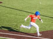 Ridgefield's Clay Madsen tries to beat out a throw in a 2A district championship baseball game Friday at Propstra Stadium. Ridgefield won 4-2.