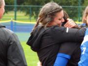 Mountain View head coach Ashleigh Byrne hugs junior second baseman Maelyn Ocampo after receiving the fourth place trophy Saturday at the 3A state tournament at the RAC in Lacey.