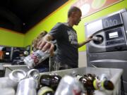 Michael Swadberg turns in bottles at a Bottledrop Oregon Redemption Center on July 31, 2015, in Gresham, Ore. Over the last year, reports of people rummaging through recycling bins have increased in Clark County. The target of these scavengers has been discarded bottles and cans, which have become increasingly valuable on the other side of the Columbia River. While local governments in Clark County have limited tools and their efforts are just starting, they could soon get help from Oregon. Last week, the Oregon Legislature passed a bill that's intended to deter people seeking to cash in on out-of-state containers.