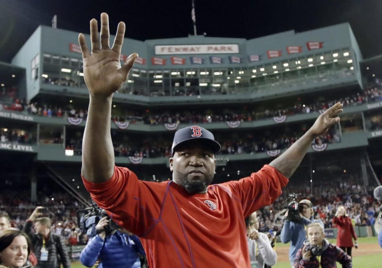 Boston Red Sox’s David Ortiz waves from the field at Fenway Park.