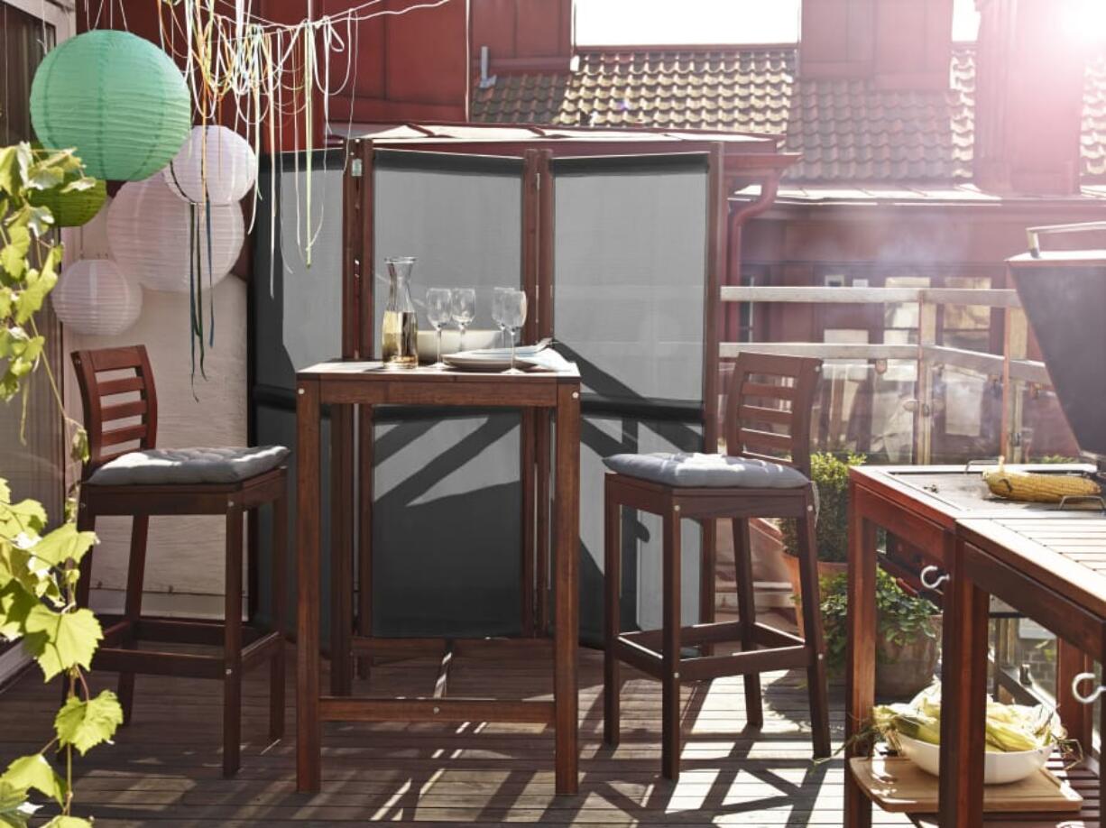 A bar table and stools add a little height to the balcony without taking up too much space.