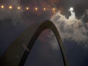 In this Aug. 21, 2017 multiple exposure photograph, the phases of a partial solar eclipse are seen over the Gateway Arch in St. Louis. Another total solar eclipse is happening July 2 in the Southern Hemisphere.